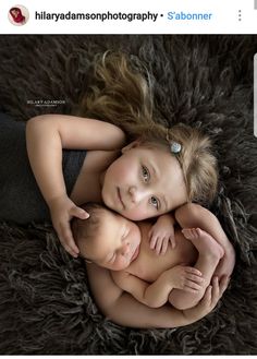 two babies are cuddling together in the middle of a fluffy blanket, with their hands on each other's chest