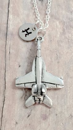 "This listing is for a hand stamped initial necklace featuring a 4/5\" x 4/5\" pewter fighter jet charm & 3/10\" stainless steel initial pendant. The silver plated chain is 18\" long, but can be made to your desired length- see photo. Please indicate chain length you would like in the 'notes to seller' section at checkout. All items are lead & nickel free. Message me with any questions, thank you! Add an initial to any necklace: https://www.etsy.com/listing/170461597/add-an-initial?ref=s Plane Jewelry, Jet Jewelry, Military Necklace, Military Jewelry, Tyler Tx, Space Galaxy, Initial Pendant, Initial Necklace, Ring Necklace