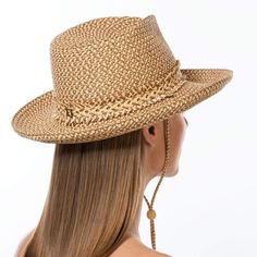 Tucson is a designer woman's sunhat for sale made of Squishee®. The modified Western shape has a fringe edged band and a self bolo braid chin strap with a wood bead to adjust and secure it. The signature logo rivet is discretely placed at the back of the crown. The wired brim permits shaping; push up the sides for more Western flare, or flatten them out for additional shade. Squishee® is a man-made material incorporating recycled fibers. It looks and feels just like natural raffia but has the ad Country Style Hat Bands For Spring Travel, Adjustable Toquilla Straw Fedora For Travel, Adjustable Beige Fedora In Toquilla Straw, Adjustable Woven Fedora With Curved Brim, Adjustable Country Style Panama Hat For Kentucky Derby, Adjustable Brown Woven Fedora, Elegant Adjustable Straw Hat With Upf 50+, Bohemian Adjustable Panama Hat For Travel, Country Style Adjustable Sun Hat For Travel