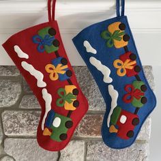 two christmas stockings hanging from a fireplace