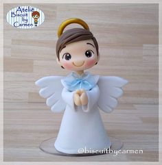 a little angel figurine sitting on top of a table