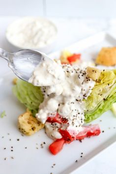 a white plate topped with salad and dressing