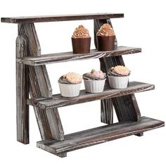 three tiered wooden shelf with cupcakes on it