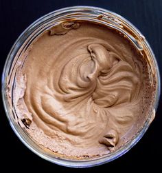 a bowl filled with chocolate frosting on top of a table