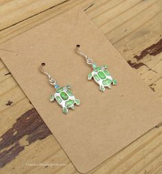 Earrings Turtles Sterling Silver Gaspite and Opal Inlay Measures: 1" (with hooks) Stamped "Sterling" (size and color may vary) Green Adjustable Jewelry With Matching Earrings, Nickel-free Green Sterling Silver Jewelry, Nickel-free Green Jewelry In Sterling Silver, Hypoallergenic Green Sterling Silver Jewelry, Green Sterling Silver Earrings With Ear Wire, Turquoise Jewelry With French Hook For Gift, Nickel-free Green Earrings For Gift, Adjustable Green Sterling Silver Jewelry, Adjustable Jewelry With French Hook As A Gift