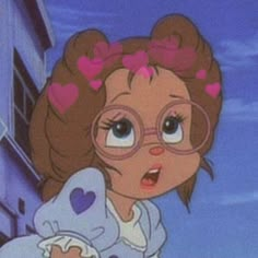 a cartoon girl with glasses and hearts on her hair is holding a teddy bear in front of a building