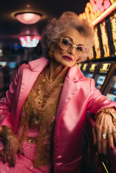 an older woman in pink jacket and glasses leaning on slot machine at casino with neon lights