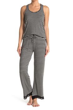 Lounge in ultimate comfort in this super soft scoop neck tank and pajama bottoms set. 2-piece set Top: 24" length; Pants: 13" rise, 29" inseam (size S) Top: scoop neck, sleeveless, racerback, knit construction, lace trim Bottoms: elasticized drawstring waist, pull-on style, knit construction, lace trim 95% rayon, 5% spandex Machine wash Imported Model’s stats for sizing: 5’11” height, 32” bust, 24” waist, 34” hips. Model is wearing size S. Casual Sleeveless Sleepwear For Lounging, Casual Sleeveless Sleepwear For Loungewear, Casual Black Sleeveless Sleepwear, Casual Sleeveless Sleepwear, Casual Striped Sleepwear, Striped Casual Sleepwear For Pajama Party, Pajama Bottoms, Sleepwear Robe, Honeydew