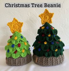 two crocheted christmas trees sitting next to each other