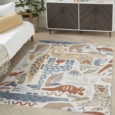 a living room area with a rug, dresser and bed in the background that has an animal motif on it