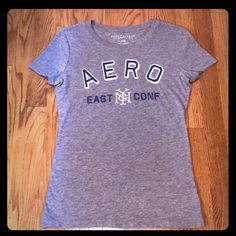 Nwot Aeropostale Nyc East Conf T-Shirt Which Efinitely Has A Ny Baseball Feel To It Is The Perfect Go To T-Shirt To Slip On With A Pair Of Jeans, Yoga Pants Or Shorts And Hit The Day Running. Vintage Aeropostale, Aeropostale Shorts, Aeropostale Tops, Aeropostale Graphic Tees Women, Ny Baseball, Aeropostale Jeans, Aeropostale, Yoga Pants, Slip On