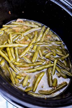 green beans are cooked in the crock pot with sauce on top, ready to be eaten