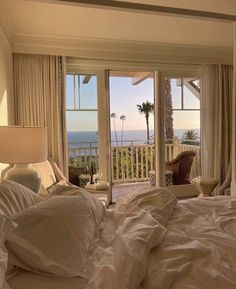 a bedroom with an ocean view is shown