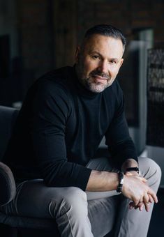 a man sitting in a chair with his arms crossed