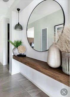 a mirror sitting on top of a wooden shelf