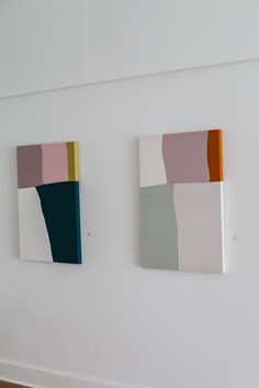 two paintings are hanging on the wall next to each other