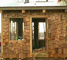 a small building made out of wood with windows