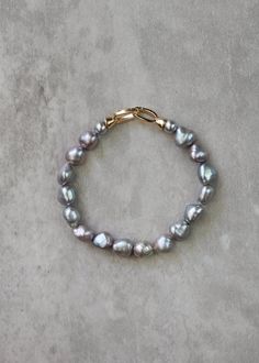 *Enjoy 10% off for a limited time. Use coupon code LIMITED10 at checkout. Does not include bespoke or custom changes. A chic, modern twist on your grandmother's classic pearls, the Rocco pearl bracelet is an elegant accessory featuring lustrous grey pearls, each exuding a contemporary sophistication while paying homage to timeless tradition. Perfect for any occasion, this bracelet effortlessly transitions from daytime grace to evening glamour. * DETAILS * > Designed and handmade in Australia > G Elegant Gray Bracelets As Gift, Elegant Gray Bracelet As Gift, Elegant Gray Bracelets For Gift, Elegant Gray Bracelet For Gift, Mother Of The Bride Gift, Grey Wedding, Gray Weddings, Freshwater Pearl Bracelet, Wedding Jewelry Bracelets