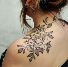 a woman with a flower tattoo on her neck