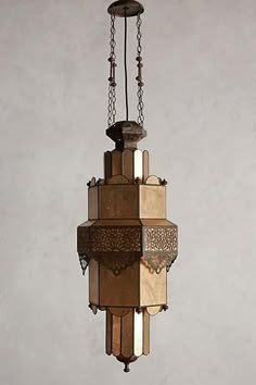 a chandelier hanging from the ceiling in an old - fashioned style with multiple shades of brown