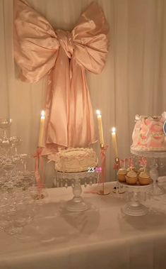 a table topped with lots of cakes and cupcakes