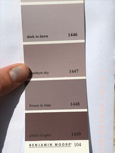 a person holding up a color swatch in their hand