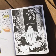 an open notebook with a drawing of a ghost in the woods and words written on it