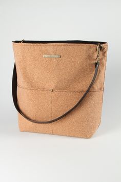 This vegan handbag is made from sustainably sourced cork, also known as vegan leather! The perfect vegan gift, our cork bags are beautiful, naturally waterproof, stylish and sustainable. Our casual, front pocket bucket bag in cork fabric is the perfect carryall for everyday use. The single strap makes it easy to swing over your shoulder; or add a longer, crossbody strap and easily transition to hands-free shopping, sightseeing and errands. Conveniently placed pockets, durable construction and a Eco-friendly Everyday Bags With Zipper Closure, Eco-friendly Bags With Zipper Closure, Cork Bags, Cork Handbag, Aesthetic Tote Bag, Cork Bag, Casual Tote Bag, Vegan Handbags, Cork Fabric