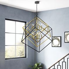 a chandelier hanging from the ceiling in a room with blue walls and stairs