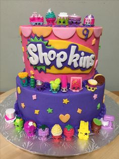 a purple cake with shopkins on it