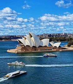 the sydney opera house and boats are in the water