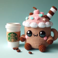 a crocheted coffee cup with a kawaity drink in front of it