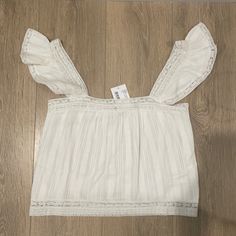 Intermix Beachclub Tamara Ruffled Cotton Top Color: White Size: P Condition: Nwt White Breezy Vacation Top, Spring Beach Tops With Ruffles, Beach Cotton Tops With Ruffled Straps, Spring Beach Ruffle Tops, Summer Tops With Ruffled Straps For Brunch, Spring Beach Ruffled Tops, Vacation Tops With Ruffles And Ruffled Straps, White Tops With Ruffled Straps And Details, White Tops With Ruffled Straps