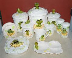 there are many frog cups and saucers on the counter