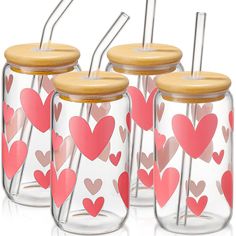 four glass jars with wooden lids and straws in hearts on the inside one has a bamboo lid