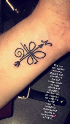 a tattoo on the wrist with an arrow