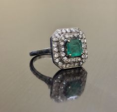 DeKara Designs Classic Handmade Art Deco Oval Emerald and Diamond Ring. Metal- 14K Yellow Gold, .583 Stones- 1 Square Emerald Cut Colombian Emerald 0.80 Carats, 33 Round Antique Old Mine Cut Diamonds F-G Color SI1 Clarity 0.85 Carats. Art Deco Inspired 14K Yellow Gold Halo Emerald Diamond Engagement Ring. The emerald has a beautiful green and is professionally set in between four prongs. There are two rows of pave set round near colorless antique old mine cut diamonds. The ring has an Art Deco i Heirloom Emerald Ring With Halo Design, Timeless Hallmarked Emerald Ring For Wedding, Emerald Rings With Single Cut Diamonds For Anniversary, Classic Wedding Emerald Ring With Single Cut Diamonds, Emerald Diamond Ring For Wedding With Single Cut Diamonds, Silver Emerald Ring With Single Cut Diamonds For Wedding, Heirloom Emerald Ring With Single Cut Diamonds For Anniversary, Heirloom Emerald Ring With Single Cut Diamonds, Formal Heirloom Emerald Ring With Single Cut Diamonds