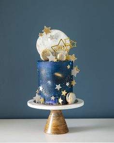 a blue and gold birthday cake with stars on it