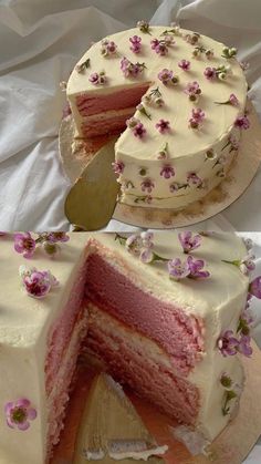 a cake with white frosting and pink flowers on it