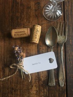 silverware and wine corks on a wooden table