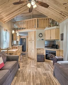 a living room filled with furniture and a ceiling fan