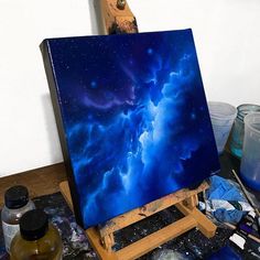 an artist's easel with paint and brushes on it