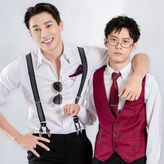 two young men in formal wear posing for the camera with their arms around each other