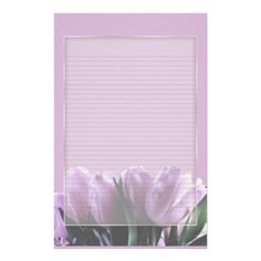 a pink lined paper with purple flowers on it