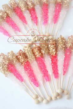 pink and gold glittered toothpicks on white background