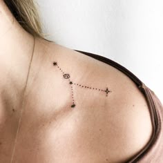 the back of a woman's shoulder with an arrow and stars on it