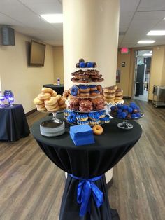 a table topped with lots of donuts and pastries