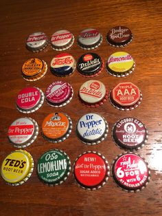 many different types of soda bottle caps on a table