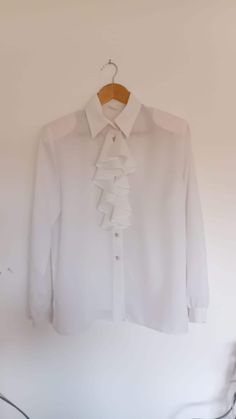 Vintage semi sheer festival blouse with folds in mint condition. Made in Yugoslavia 1980s. Faded labels. Size: XL us women's letter Will best fit women size EU: 50, ZDA: 20, UK: 24   Material: Feels like polyester. Padded shoulders - removable. Pointed collar. Pearl buttons. Length: 58 cm - 22, 83 inch Sleeves: 56 cm - 22,00 inch Bust: 116 cm - 45,66 inch Waist: 120 cm - 47,24 inch Formal Ruffled Button-up Shirt, Vintage Ruffle Button-up Blouse, Vintage Button-up Ruffled Blouse, Vintage Button-up Blouse With Ruffles, Long White Blouse, Handmade Wool Scarf, Puff Sleeves Top, Ruffle Long Sleeve Blouse, White Blouse Top