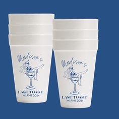 four white cups with the last toast logo on them are sitting side by side in front of a blue background